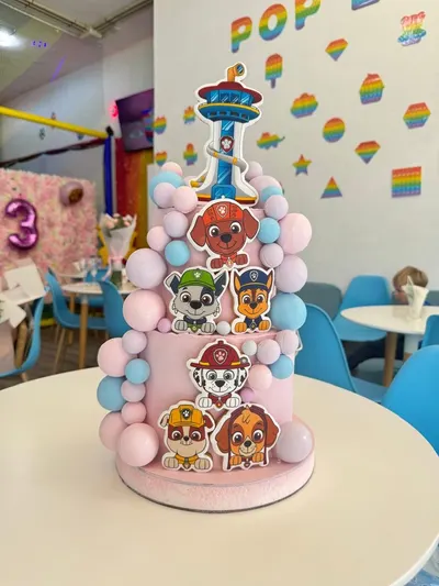 Tarta rosa de dos pisos de la Patrulla Canina con galletas de los personajes